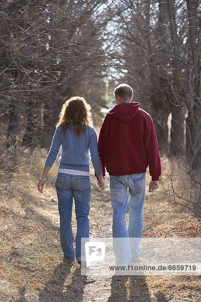 Couple Walking While Holding Hands