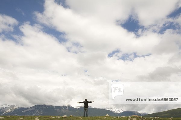 Person On A Hill With Arms Outstretched