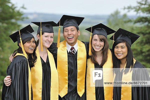 Diverse University Graduates Outside Together