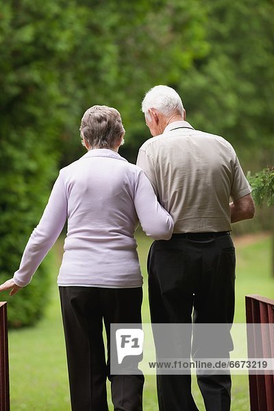 An Elderly Couple Walking Together