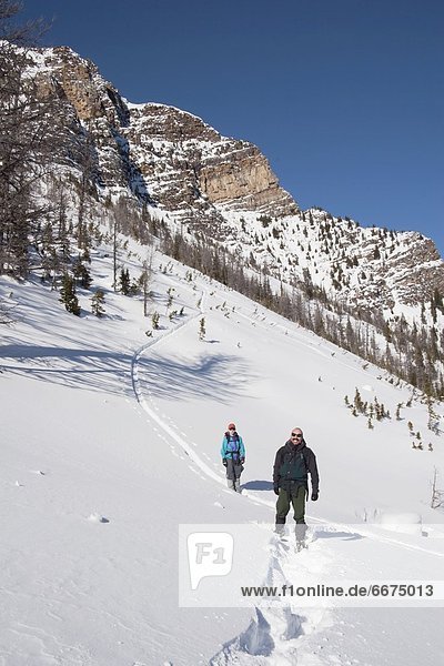 Couple On Snowshoes On A Mountain