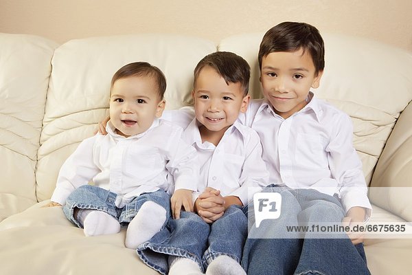 Brothers Sitting On A Couch