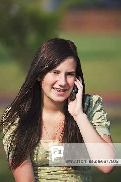 A Girl In The Park On Her Cell Phone