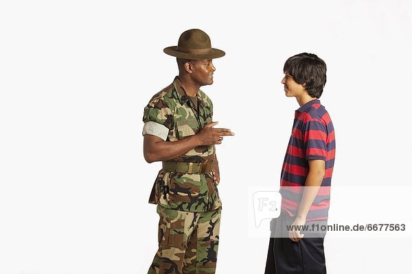 A Military Man Talking To A Teenage Boy