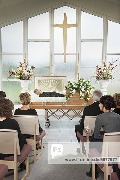 The Deceased Laying In A Coffin At His Funeral