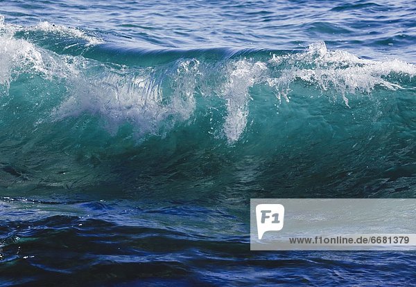 Breaking Ocean Wave In Clear Sea Water