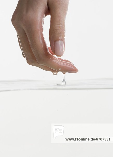 Hand touching water