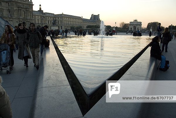 People Around Fountain In Town Square