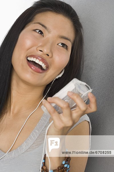 Young Woman listening to MP3 player