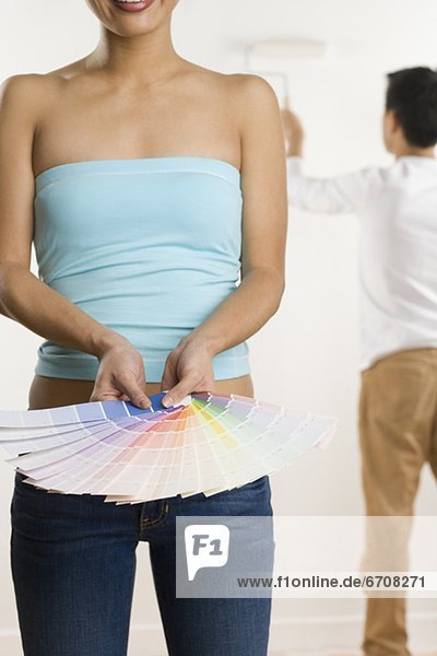 Woman holding color samples