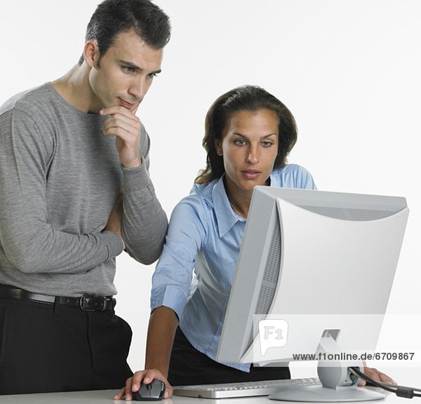 Businesswoman and businessman using computer