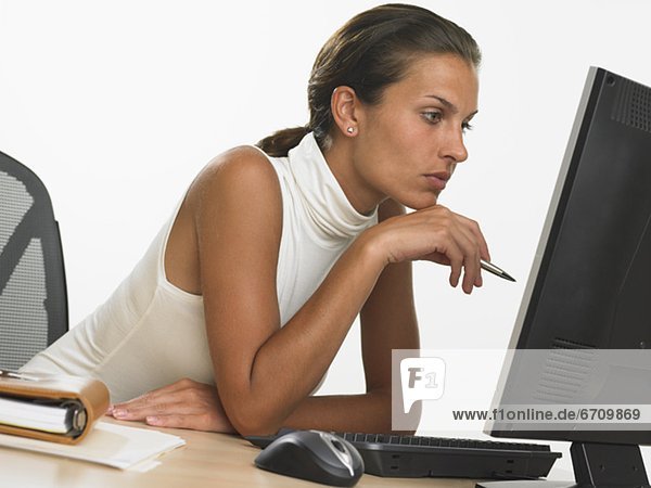Businesswoman looking at computer screen