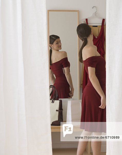 Woman in evening dress looking in mirror