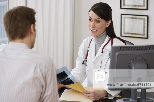 Female doctor talking to patient in office