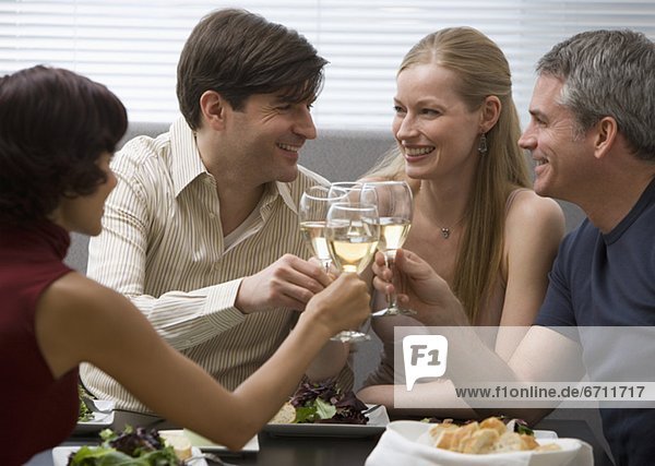 Two couples toasting at restaurant