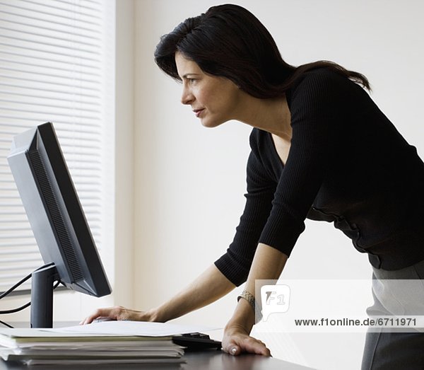 Businesswoman looking at computer