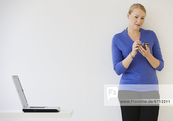 Businesswoman using electronic organizer