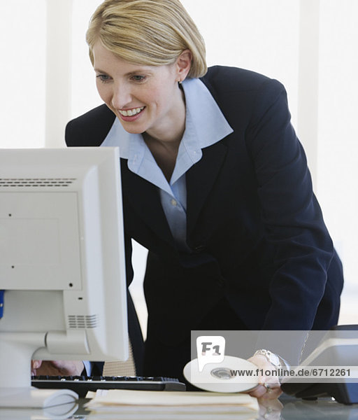 Businesswoman looking at computer