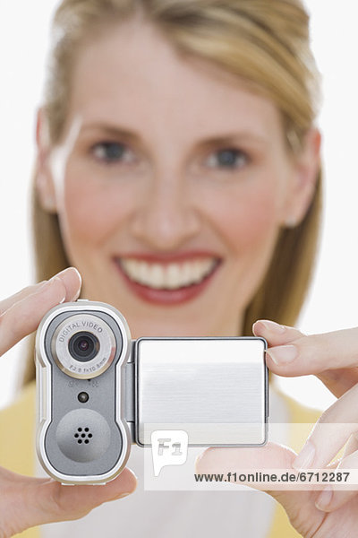 Woman holding small video camera