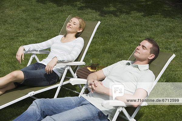 Couple sitting in lounge chairs