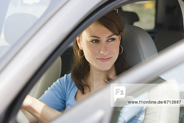 Young woman in driverÕs side of car