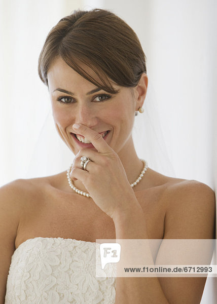Bride laughing with hand over mouth