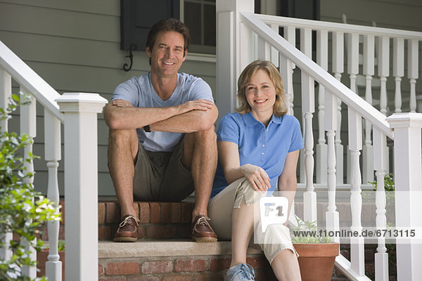 Couple sitting on porch steps