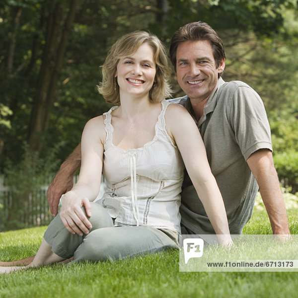 Couple sitting in grass