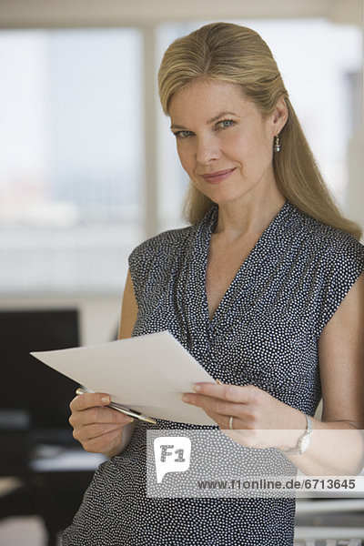 Businesswoman holding paperwork