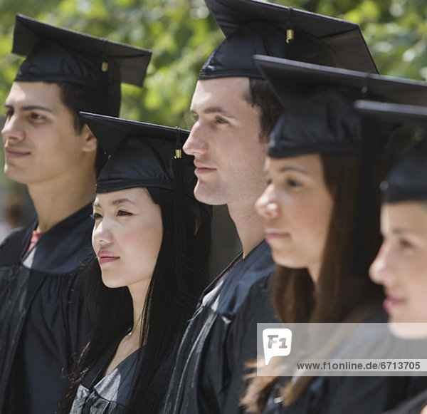 Group of college graduates in row