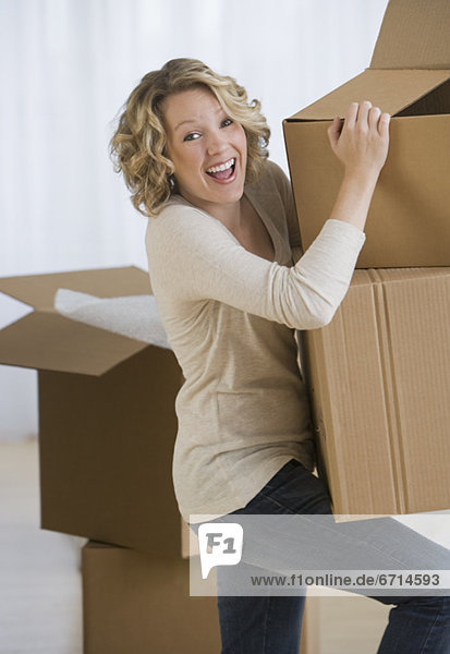 Woman carrying moving boxes