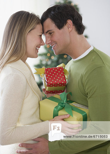 Couple with gifts hugging