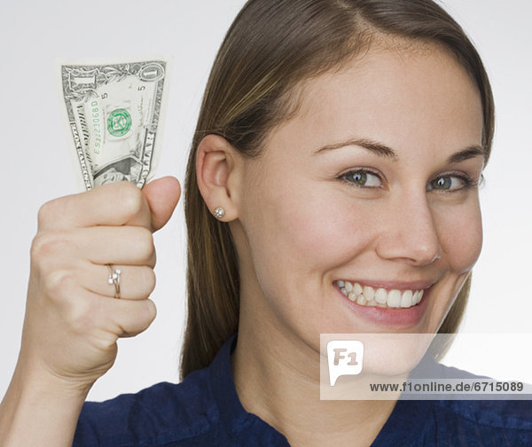 Woman holding dollar bill