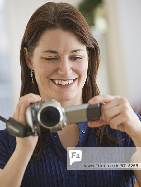 Woman looking at video camera