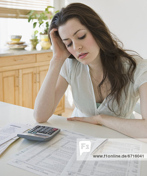 Frustrated woman looking at tax forms