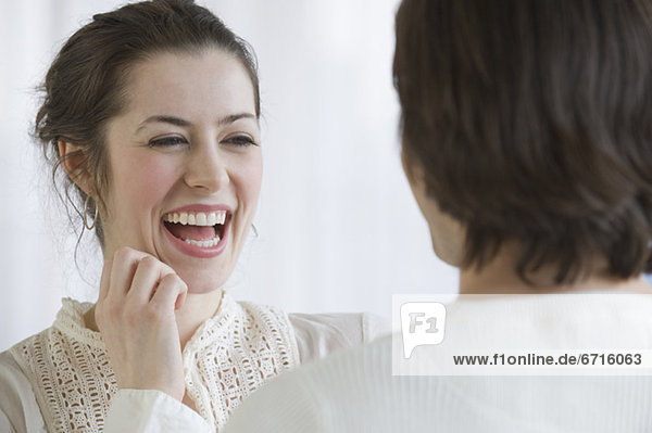 Woman laughing next to boyfriend