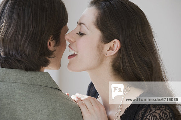 Woman whispering in boyfriendÕs ear