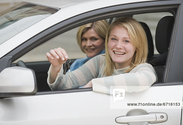 Teenaged girl in car with mother