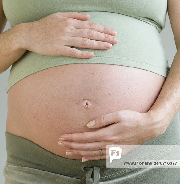 Pregnant woman with hands on belly