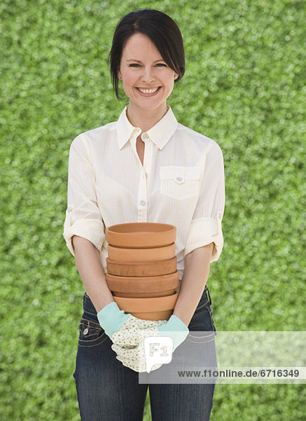 Woman holding terra cotta pots