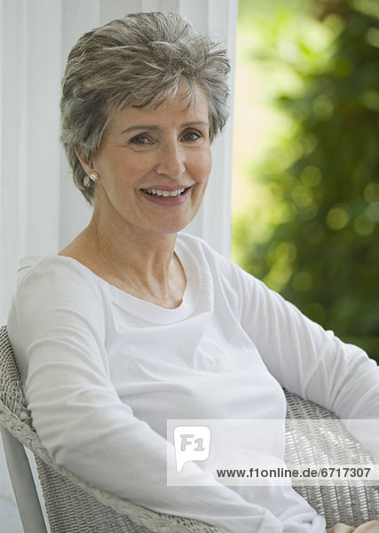 Senior woman sitting on porch