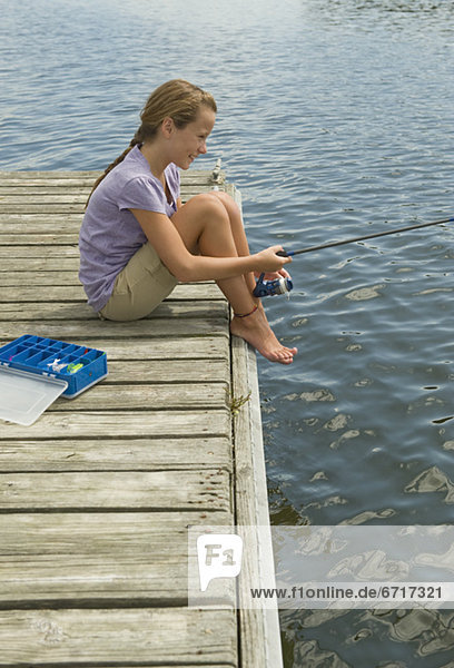 Girl fishing off dock
