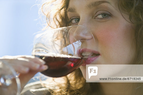 Close up portrait of woman drinking red wine