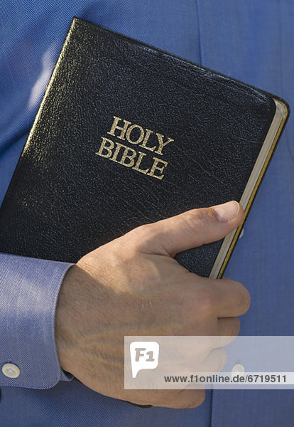 Man holding Holy Bible