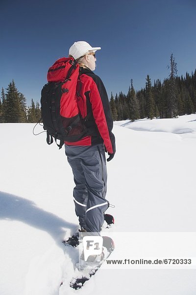 Woman In Snowshoes In The Snow