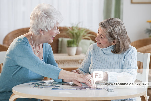 Senior women assembling puzzle