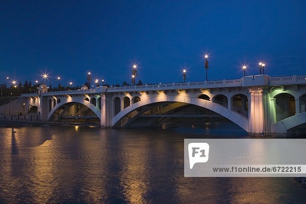 A Bridge Over A River At Night