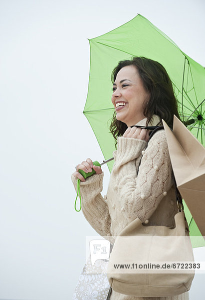 A woman with shopping bags in the rain
