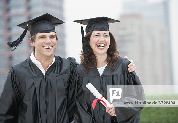 A young woman and young man graduating