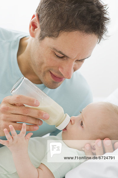 Father feeding baby